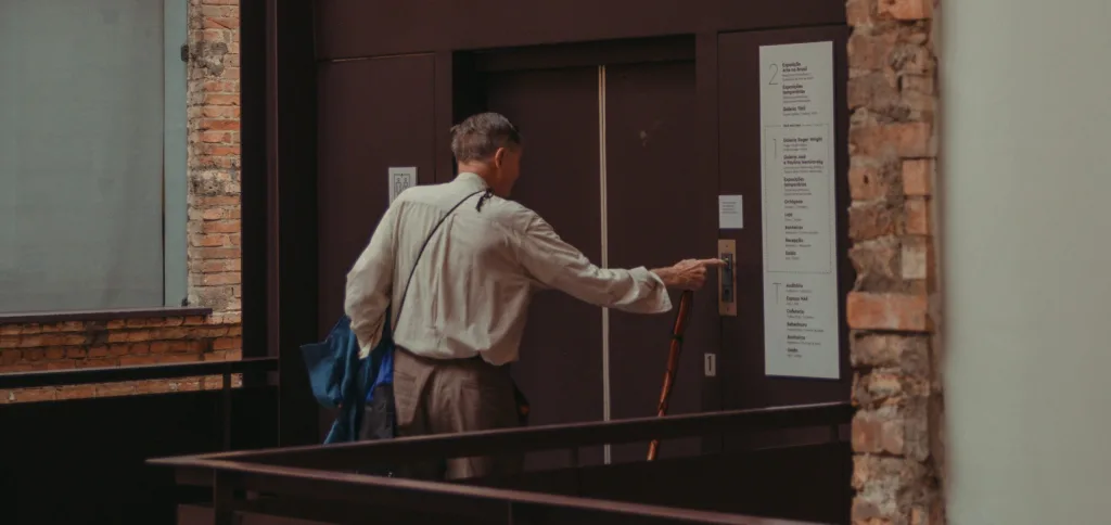 Disabled and elderly elevator riders safely use emergency devices