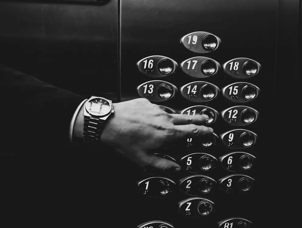 California Elevator Phone Service and Installation 16 elevator control panel with man touching buttons